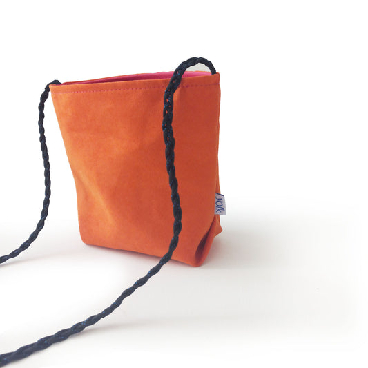 orange cross body bucket bag with black cord