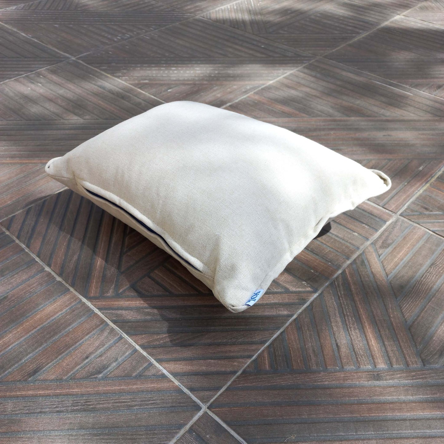 Cream white cushion on a patio floor