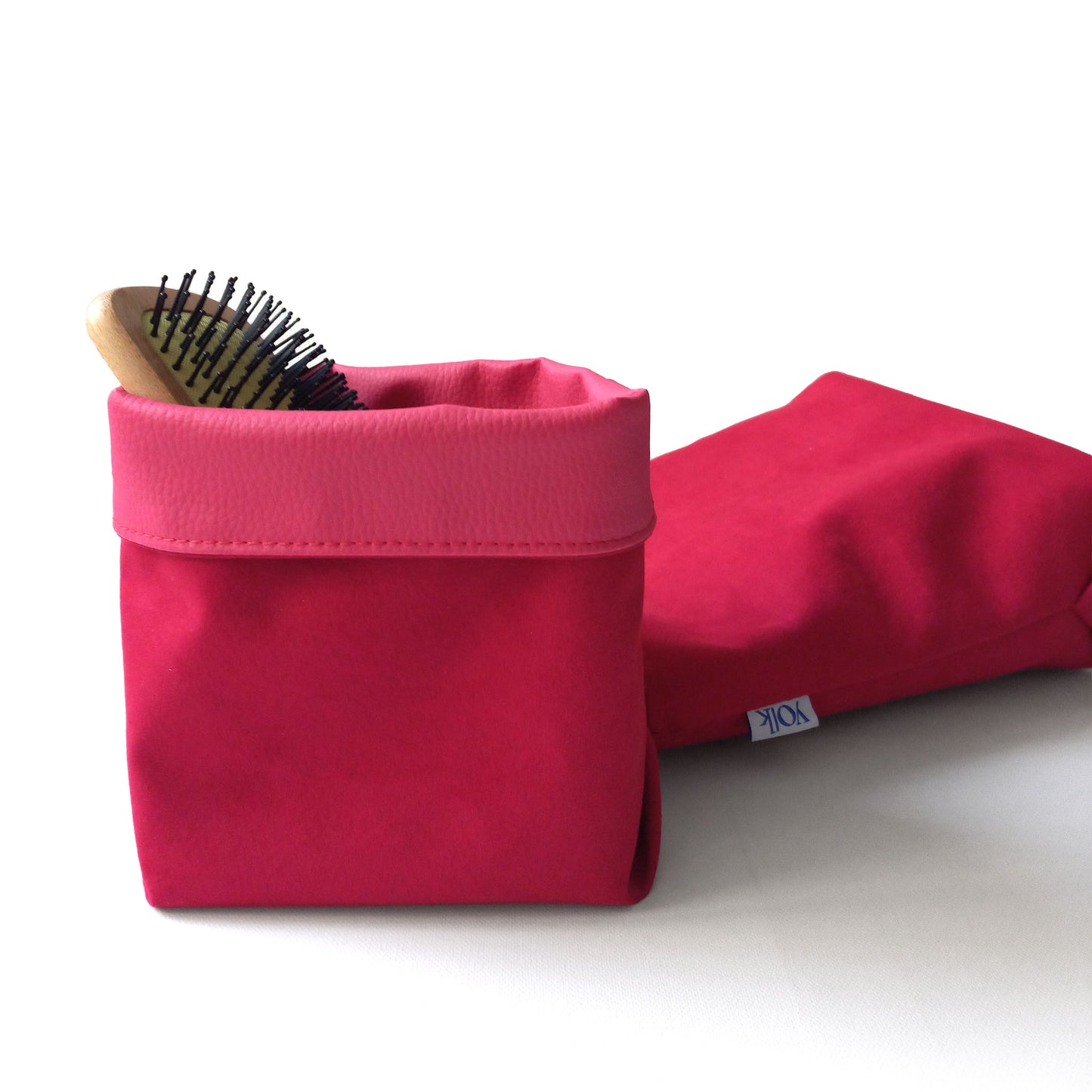 Red fabric baskets and a brush