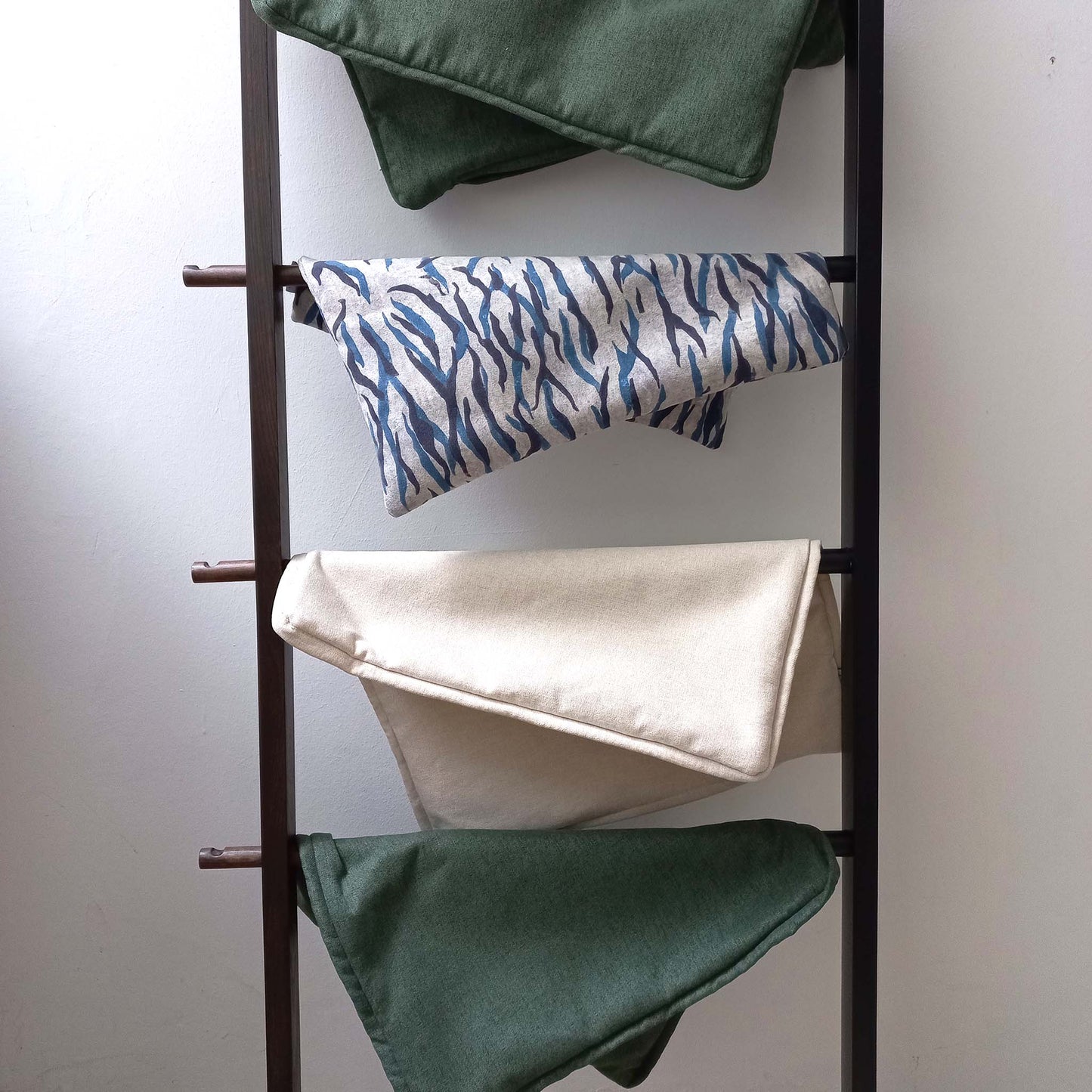 Decorative cushion covers on a ladder hanger