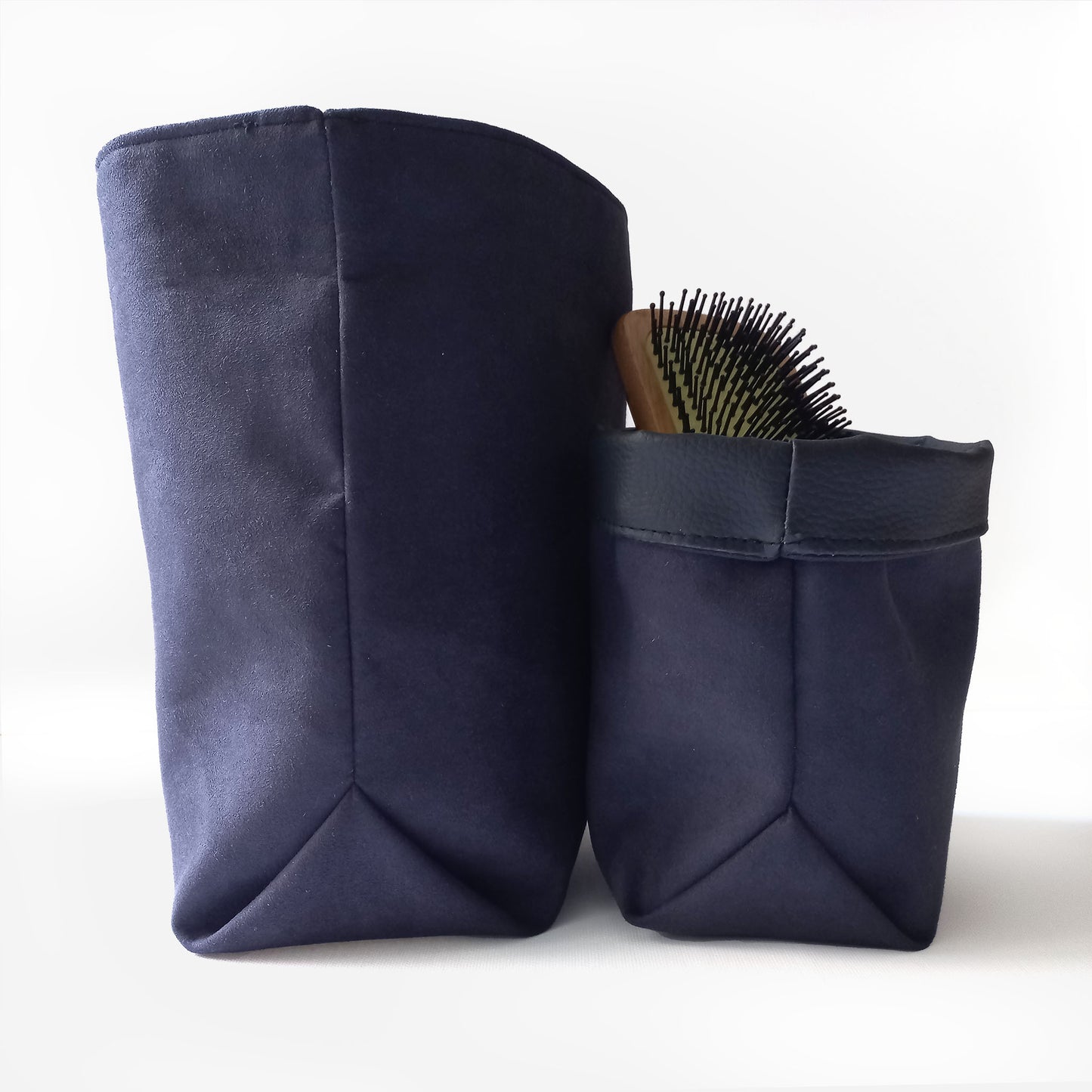 Two black baskets and a hair brush
