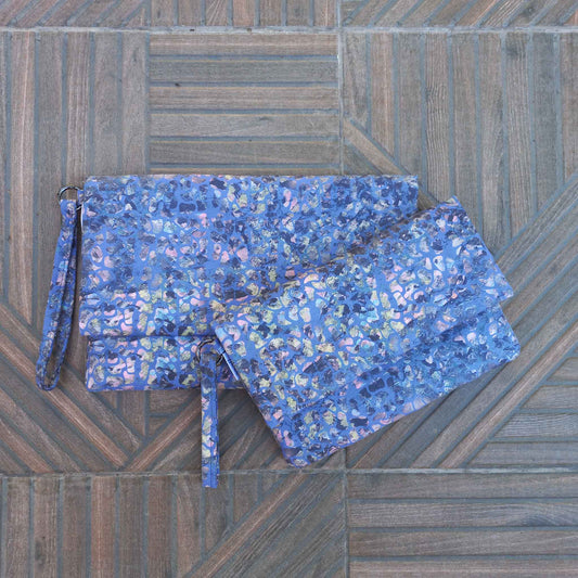 Two clutch bags on a patio floor, small and large size