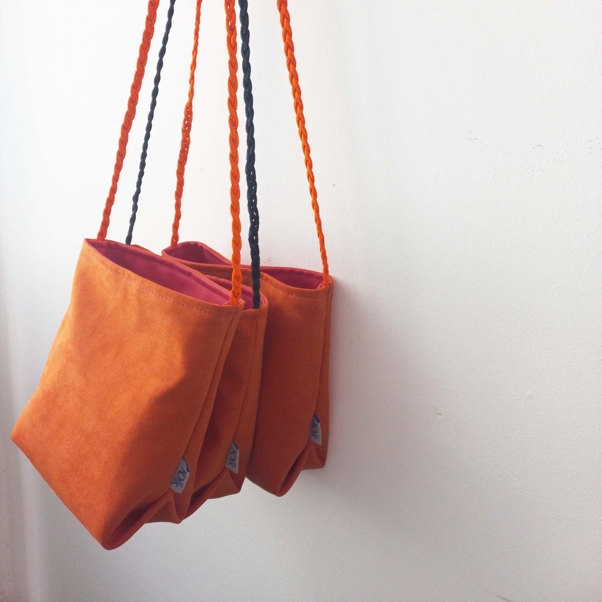 orange cross body bucket bags hanging