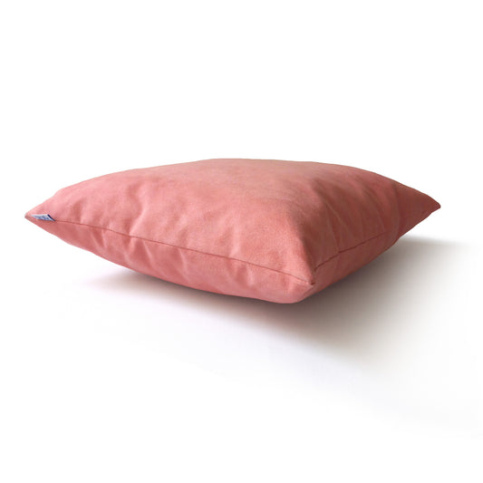 Decorative cushion in coral pink colour, side view