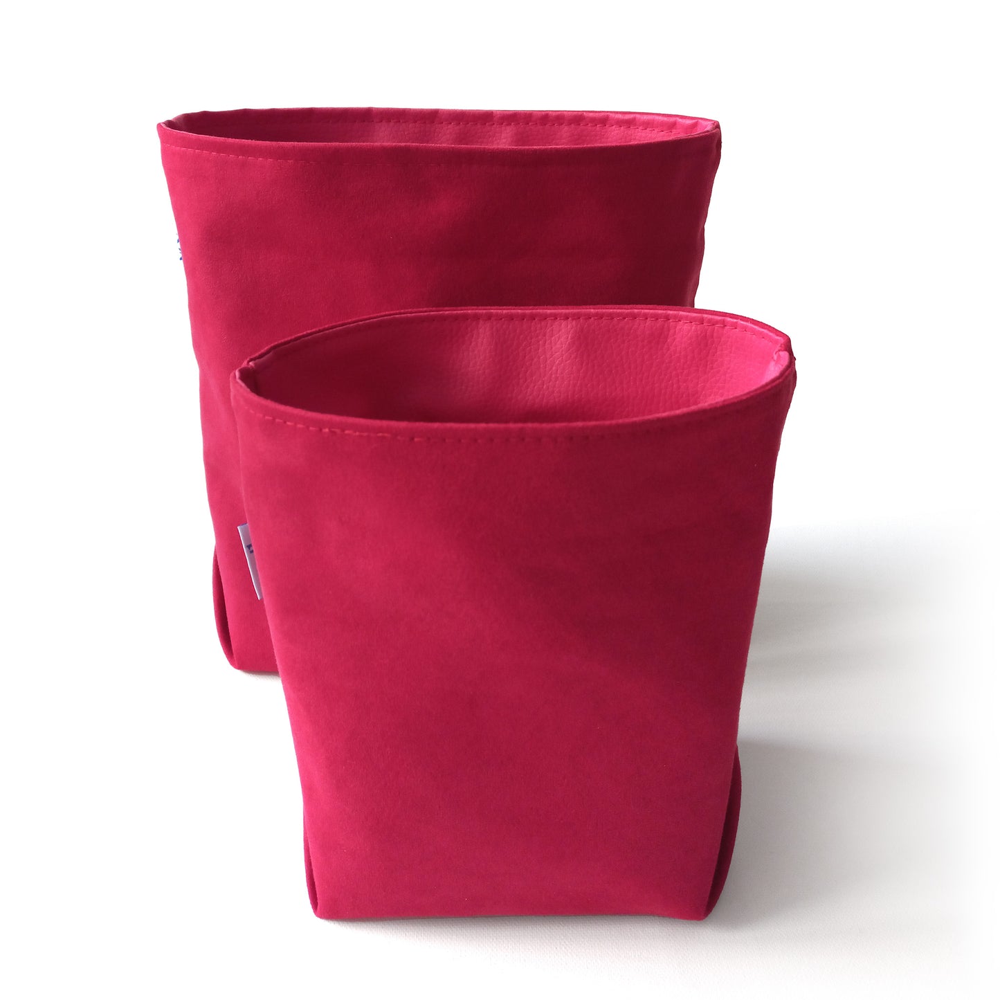 Two red fabric storage baskets