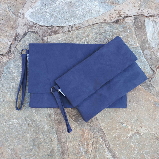 Two blue clutches on a stone floor