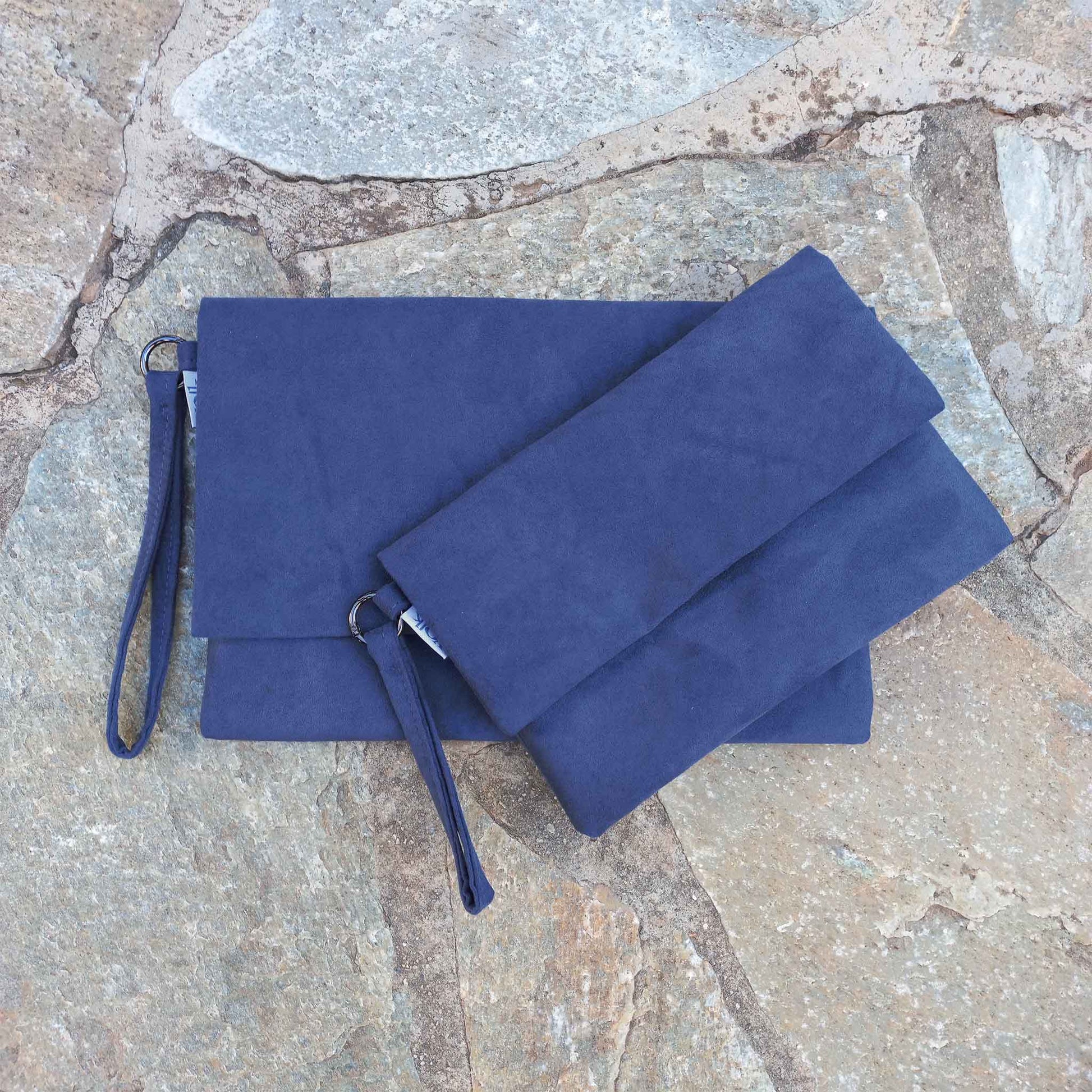 Two blue clutches on a stone floor