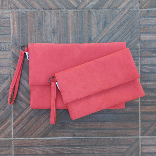 Two clutches on a patio floor, small and large size