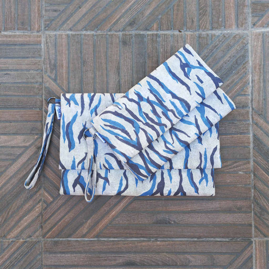 Small and large  printed fabric clutches on a patio floor