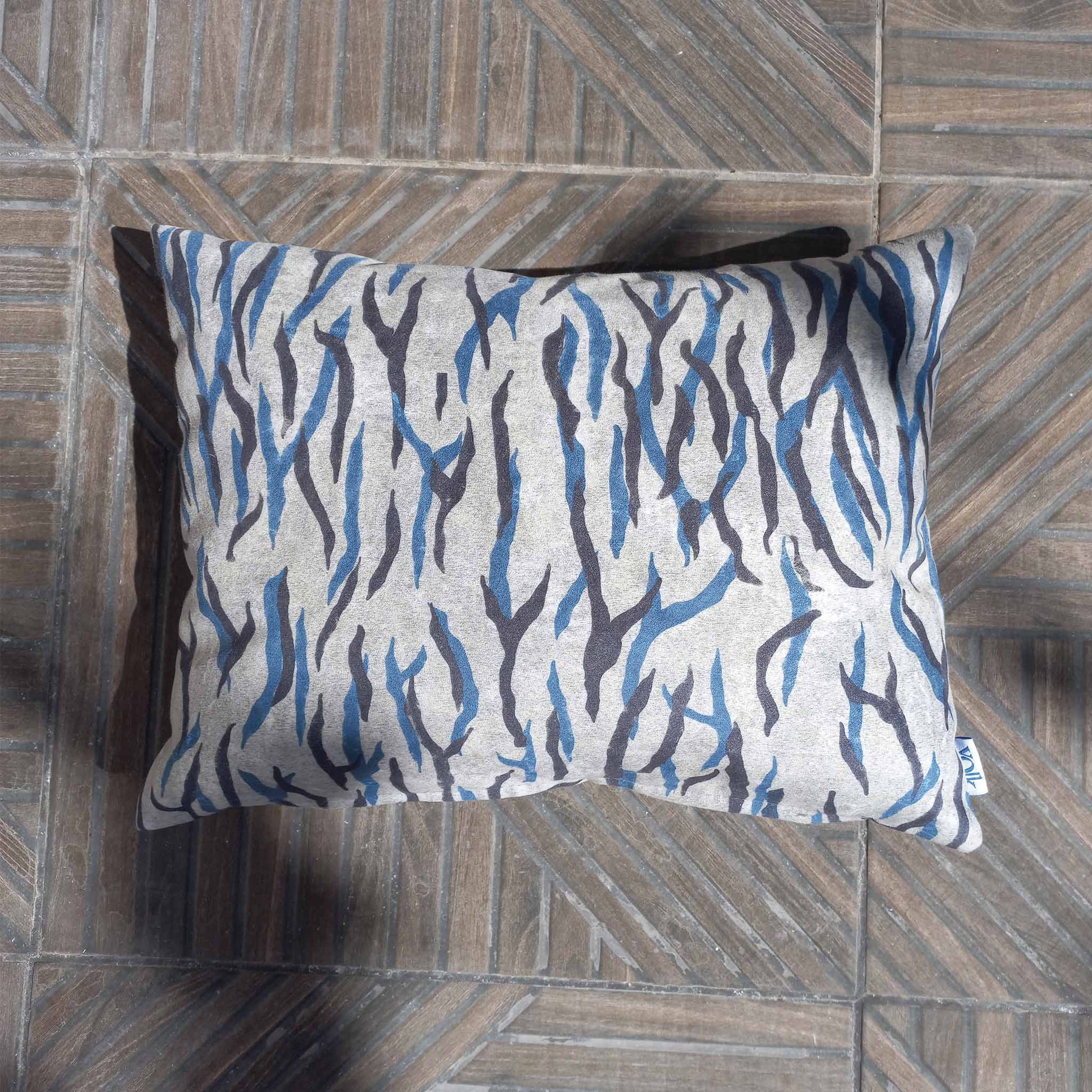 Printed decorative cushion outside on a patio floor